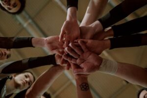A team of people's hands gathered in a circle